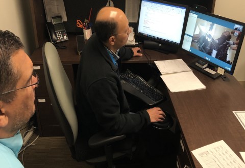 Lead Wheelchair Technician Paul Alonzo (left) participated in South Texas Veterans Health Care System’s first telehealth wheelchair fitting with Veteran Carl Johnson (on camera) and Assistive Technology Therapy Supervisor Reuben Rodriguez.